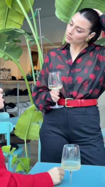 A fluid red blouse paired with sheer black florals.
Effortless contrast, natural chemistry.
Ease in conversation, elegance in motion.